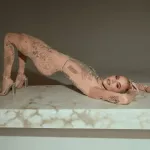 Khloé Kardashian rocks nude catsuit covered in tattoos
