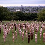 Hundreds pose nude wearing only masks in London art installation