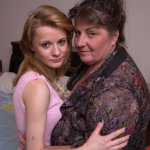 Fat mature woman and tiny teen girl engage in lesbian sex acts upon a bed