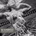 Woman swimming naked underwater
