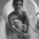 A naked woman sitting in a bath tub photo